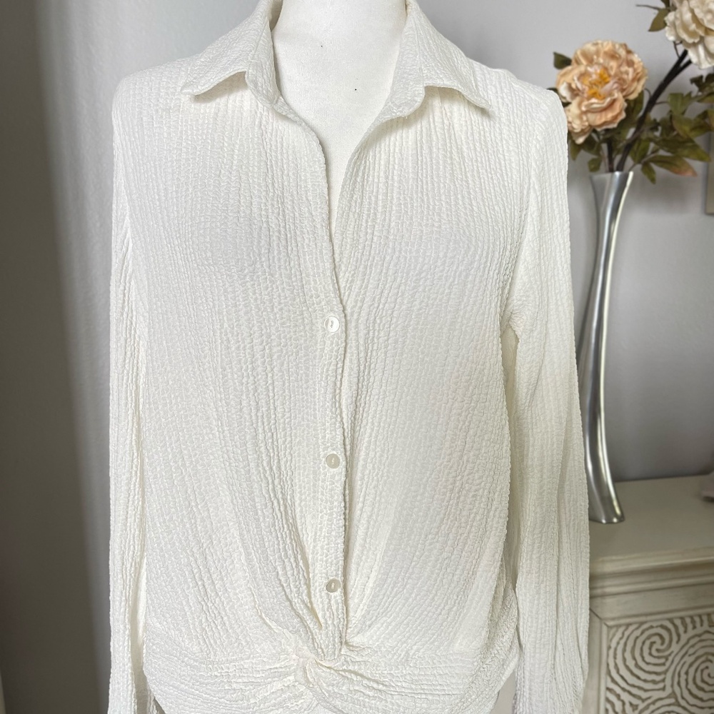 NWT This item is a BCX long sleeve blouse twist front at the hem